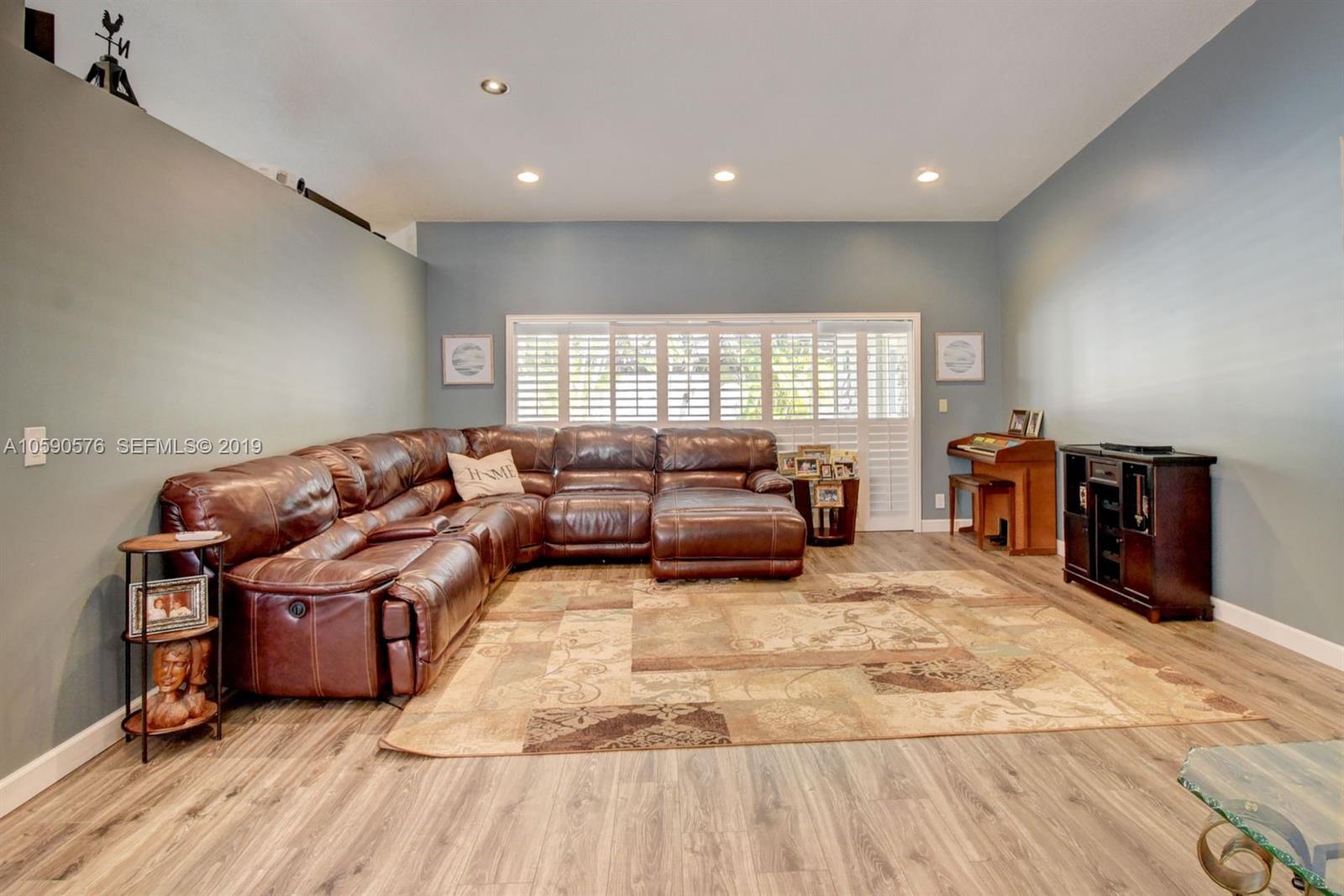 22324 Boyaca Avenue Boca Raton, FL 33433 - Photo 30 of 51 a living room with furniture and a flat screen tv