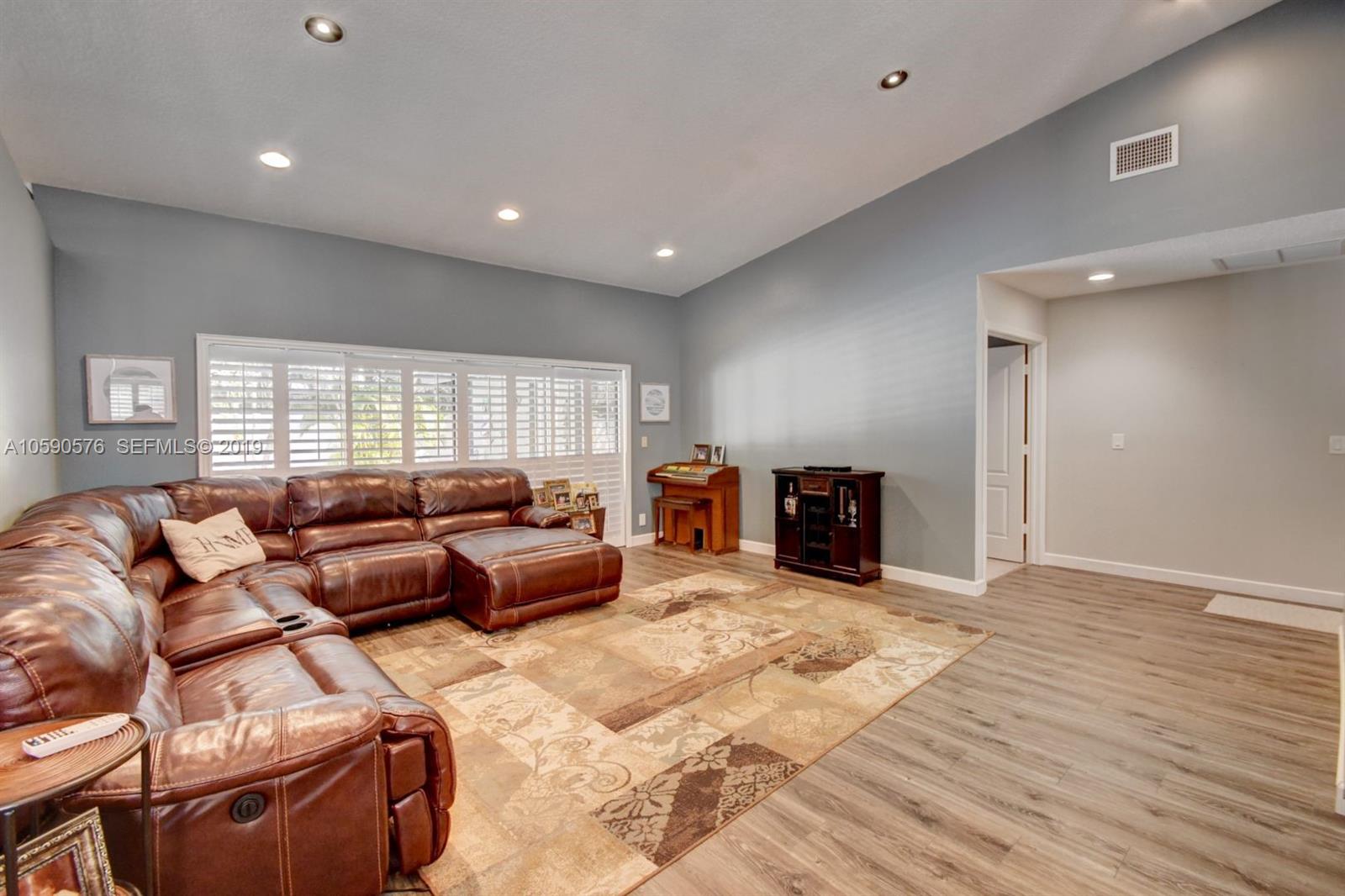 22324 Boyaca Avenue Boca Raton, FL 33433 - Photo 31 of 51 a living room with furniture window and a wooden floor