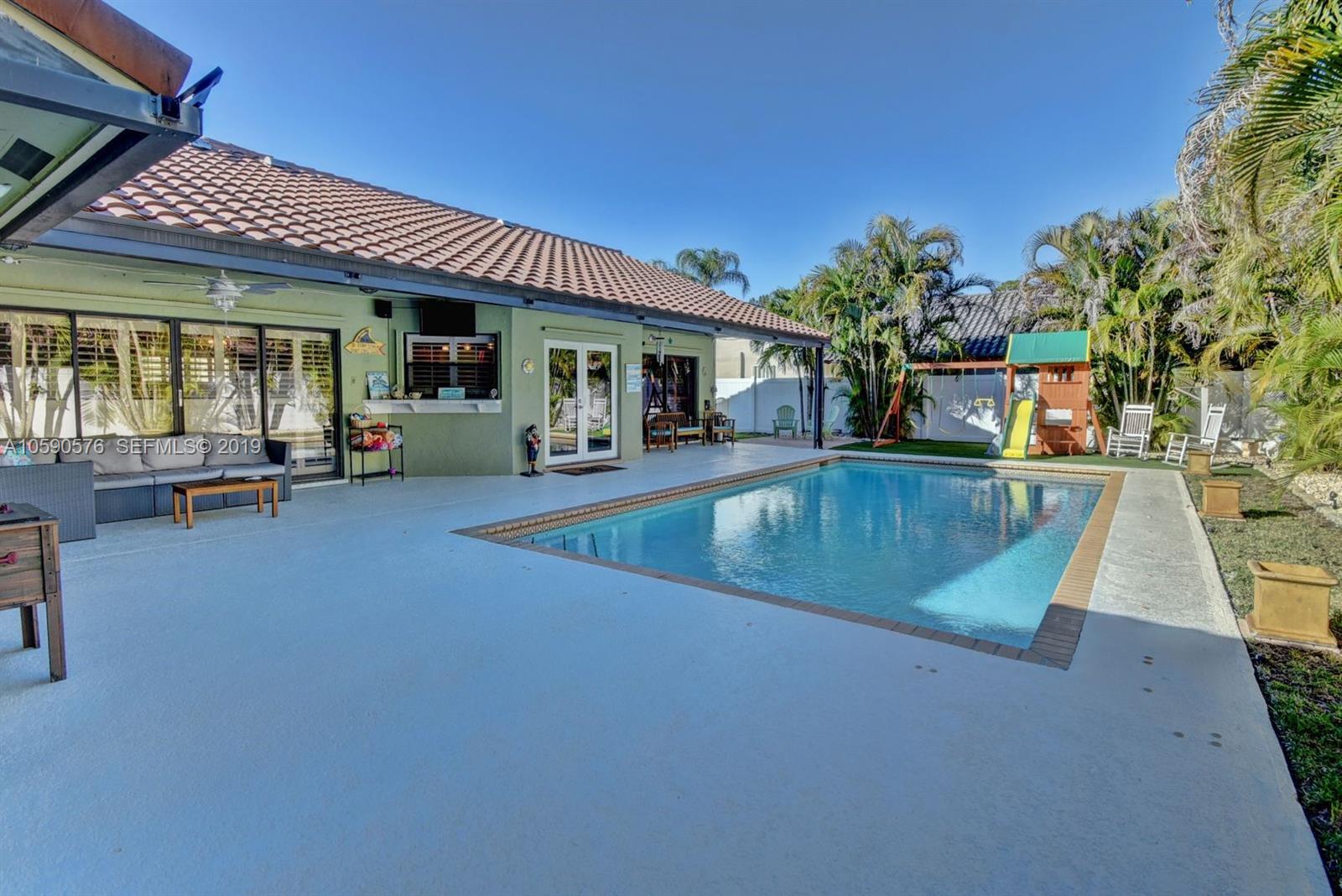 22324 Boyaca Avenue Boca Raton, FL 33433 - Photo 35 of 51 a view of a house with swimming pool and sitting area