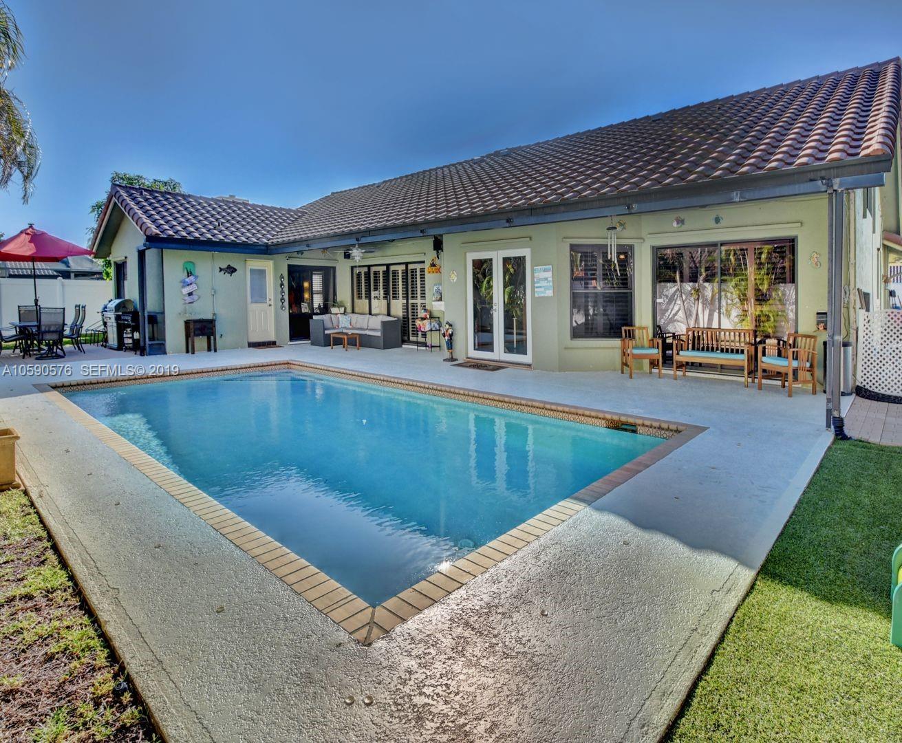 22324 Boyaca Avenue Boca Raton, FL 33433 - Photo 38 of 51 a view of a house with swimming pool and sitting area