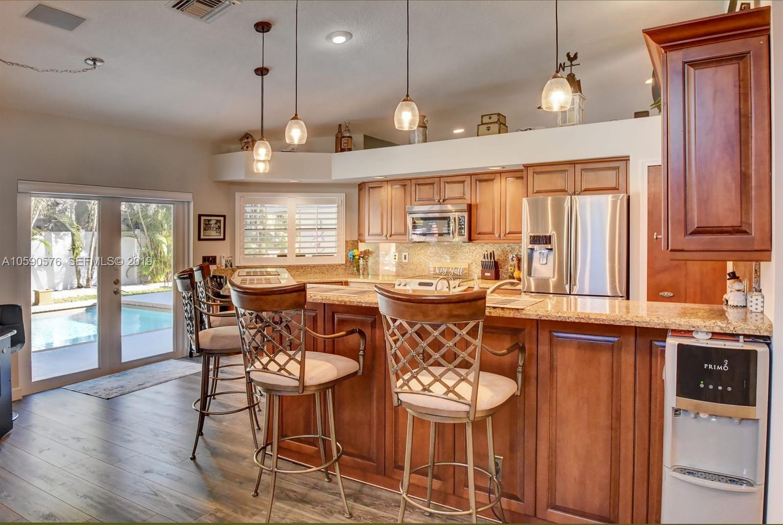 22324 Boyaca Avenue Boca Raton, FL 33433 - Photo 4 of 51 a large kitchen with a table and chairs