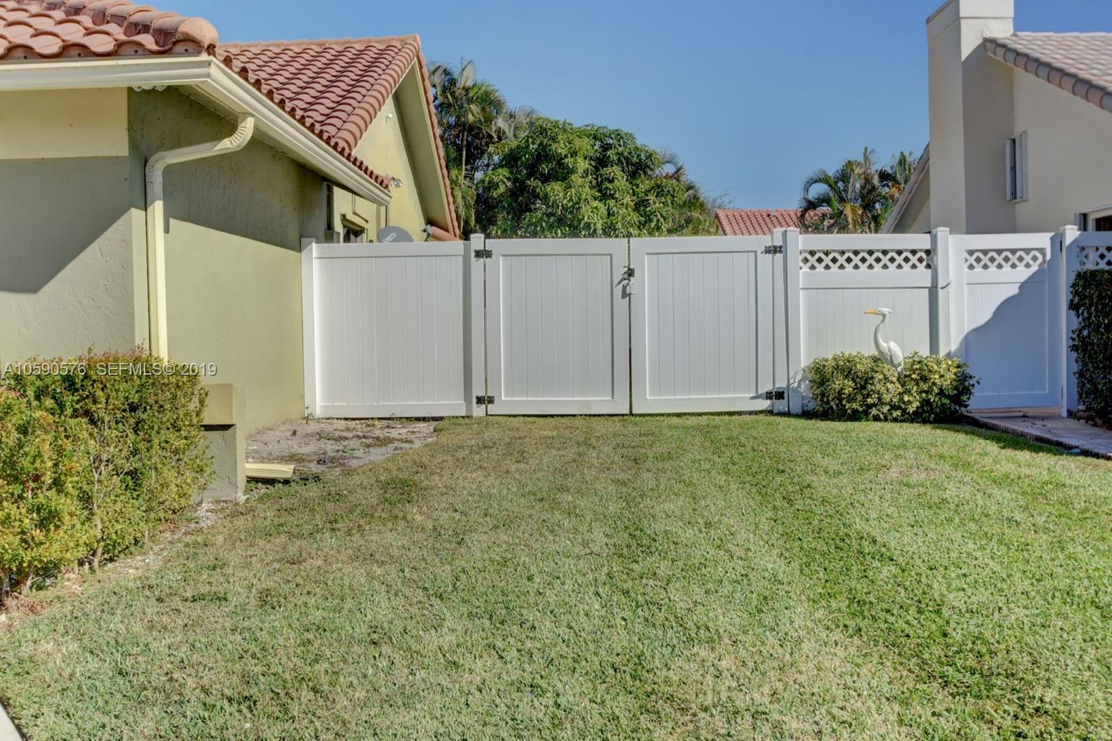 22324 Boyaca Avenue Boca Raton, FL 33433 - Photo 42 of 51 a house with trees in front of it