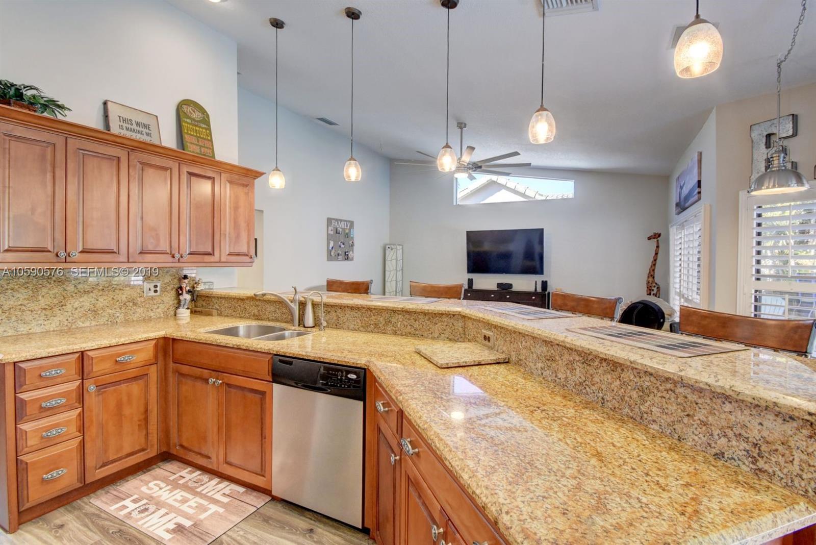 22324 Boyaca Avenue Boca Raton, FL 33433 - Photo 6 of 51 a kitchen with a sink stove and cabinets