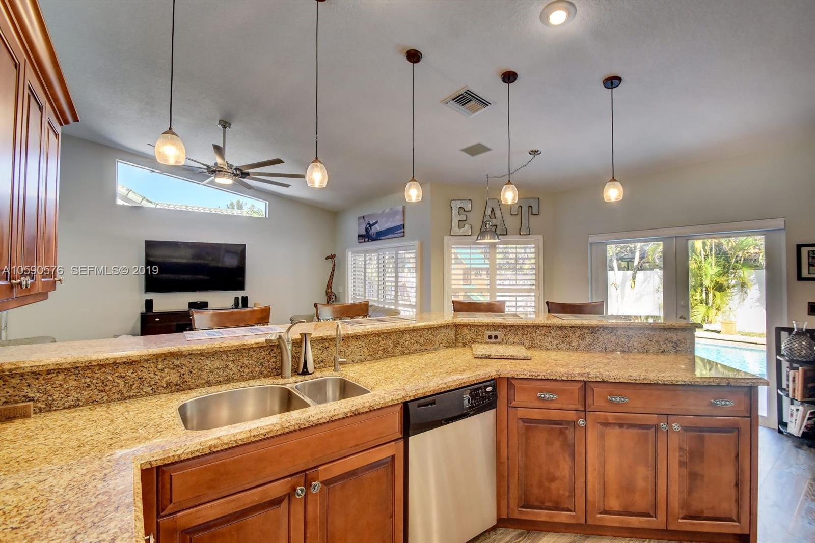 22324 Boyaca Avenue Boca Raton, FL 33433 - Photo 7 of 51 a kitchen with a stove a sink and a wooden floor
