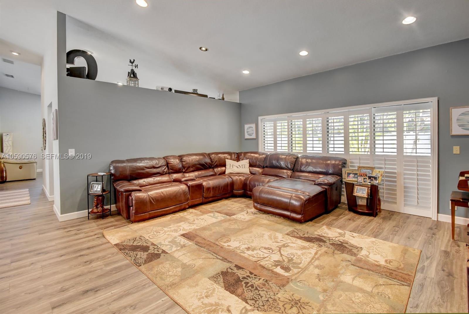 22324 Boyaca Avenue Boca Raton, FL 33433 - Photo 9 of 51 a living room with furniture and wooden floor