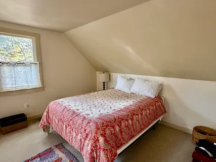 a bedroom with furniture and a window