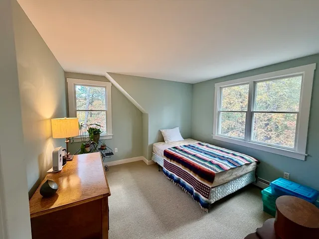 a view of roof deck with wooden floor and seating space