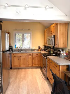 a bedroom with a bed window and mirror