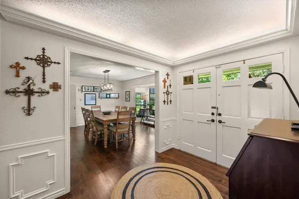 a view of a livingroom with furniture hardwood floor and a view of kitchen