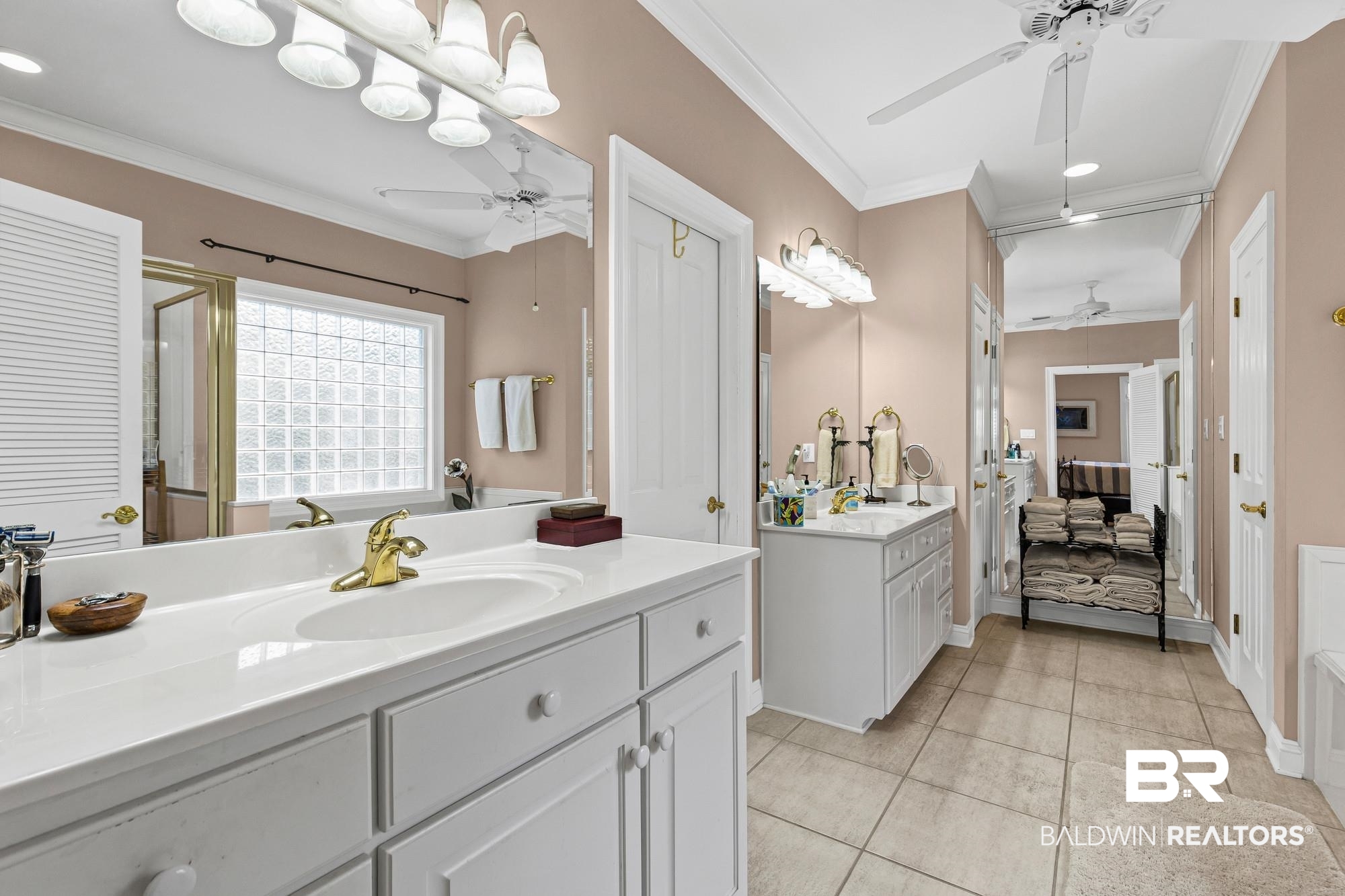 32191 River Road Orange Beach, AL 36561 - Photo 23 of 46 Ensuite bathroom with crown molding, a stall shower, two vanities, recessed lighting, and ceiling fan