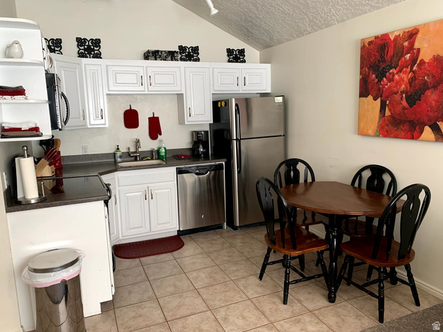 860 South Village Road, Unit B11 St. George, UT 84770 - Photo 5 of 19 Kitchen featuring dark countertops, white cabinetry, and stainless steel appliances