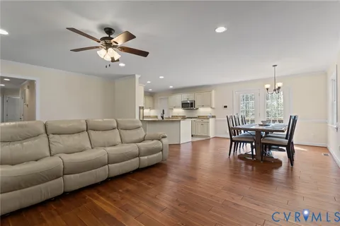 a living room with furniture and kitchen view