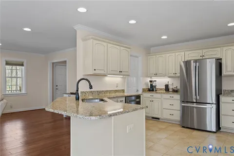a kitchen with stainless steel appliances granite countertop a refrigerator sink and stove