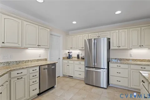 a kitchen with granite countertop cabinets and steel stainless steel appliances