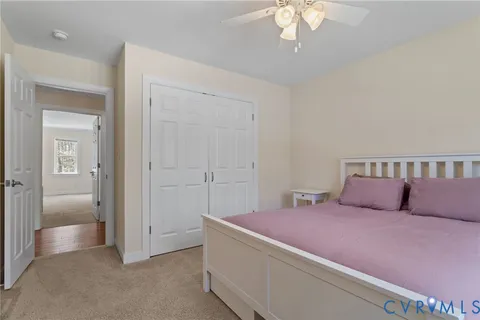 a view of an empty room with a window and dresser