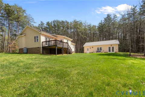 a view of a house with a yard and sitting area