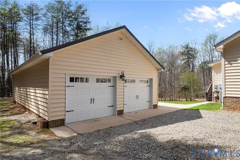 an aerial view of a house with yard and swimming pool