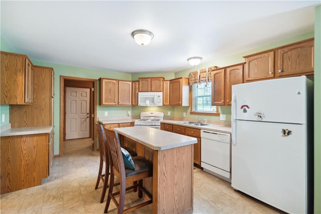 226 Cypress Road Addison, PA 15411 - Photo 6 of 31 a kitchen with a refrigerator a stove a sink and a dining table