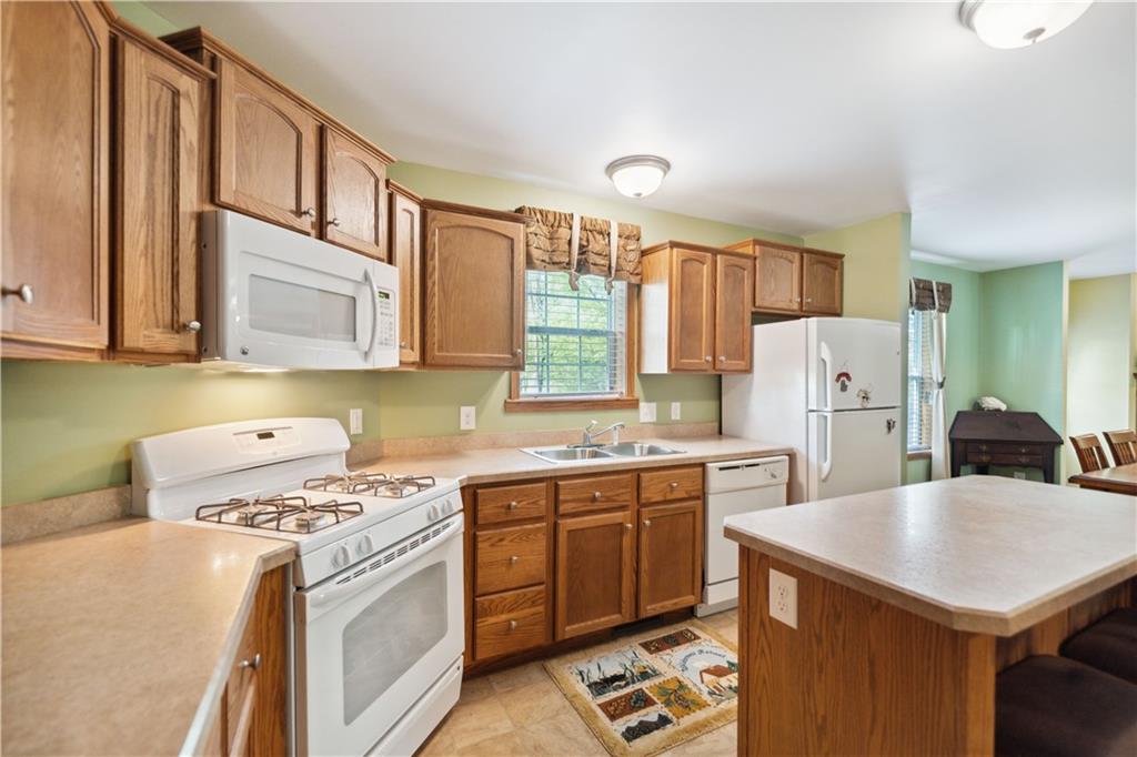 226 Cypress Road Addison, PA 15411 - Photo 7 of 31 a kitchen with stainless steel appliances a stove a sink a refrigerator white cabinets and wooden cabinets