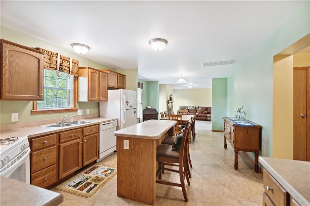 226 Cypress Road Addison, PA 15411 - Photo 8 of 31 a large kitchen with kitchen island a sink table and chairs