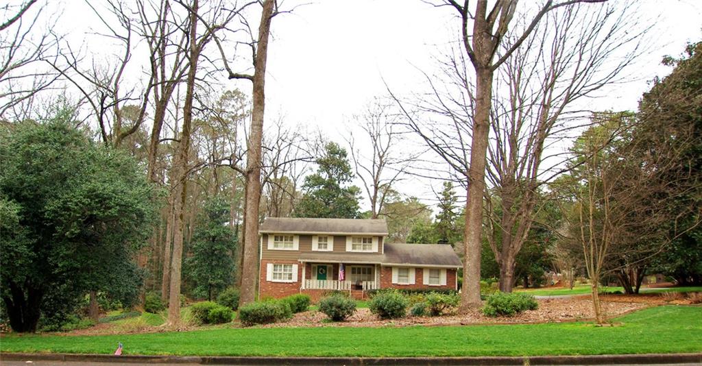 5286 Oxbow Road Stone Mountain, GA 30087 - Photo 1 of 1 a view of a big yard in front of a brick house with large windows