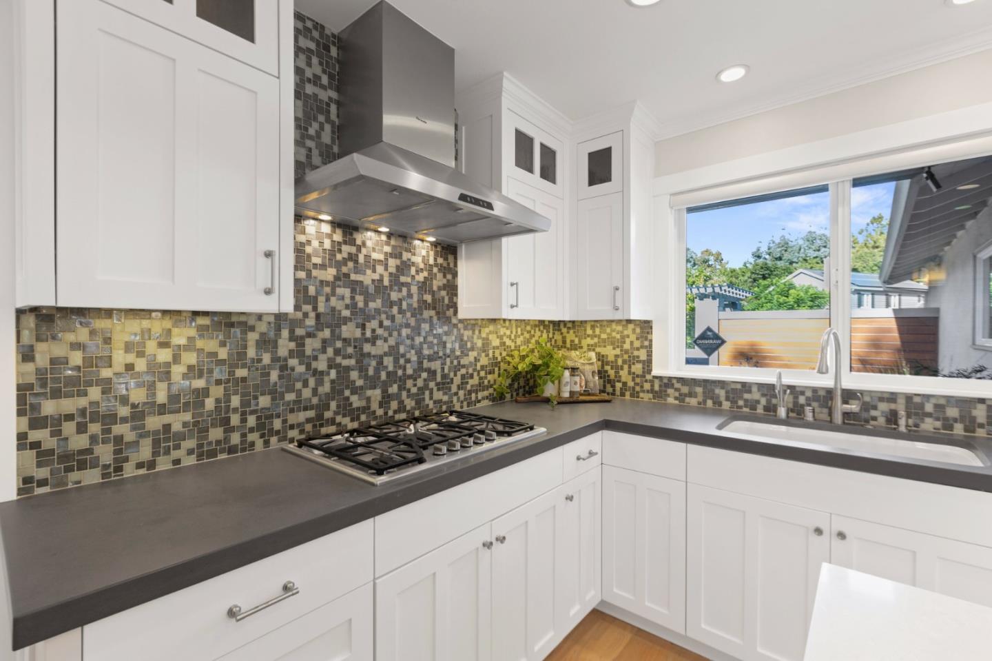 2219 Maykirk Road San Jose, CA 95124 - Photo 30 of 100 a kitchen with granite countertop a stove a sink and white cabinets with wooden floor