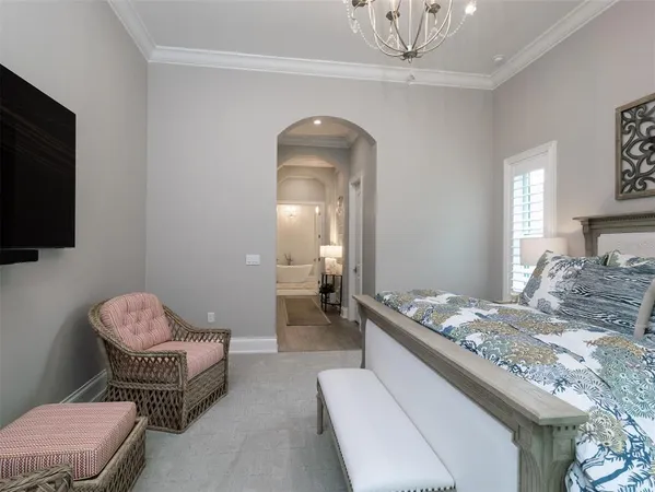 a bedroom with a bed and a chandelier