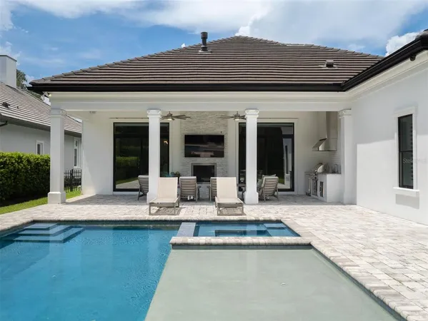 a outdoor living space with furniture potted plant and a fireplace