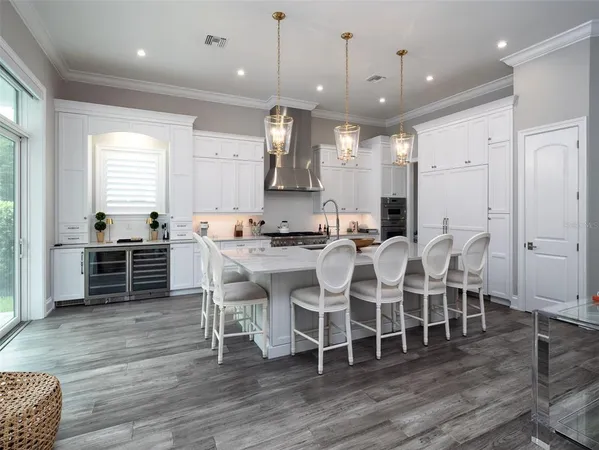 a large kitchen with a table and chairs