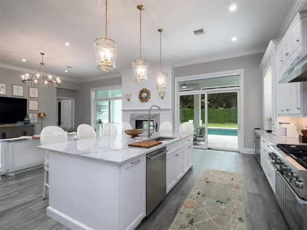 a large kitchen with kitchen island a large island in the center and stainless steel appliances