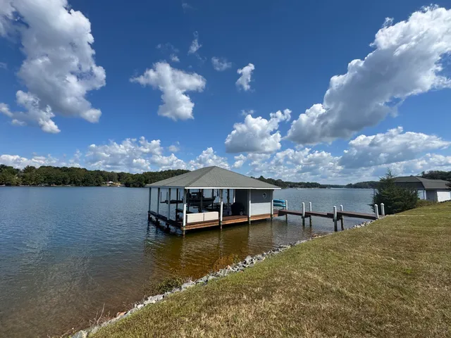 a view of house with lake view and boat