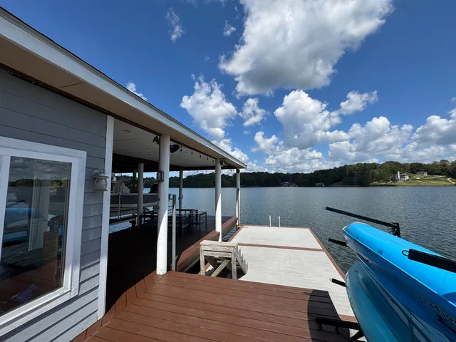 a roof deck with table and chairs a barbeque