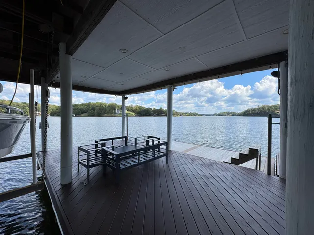 a view of a balcony with chairs and wooden floor