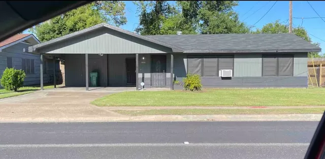 a front view of a house with a yard potted plants