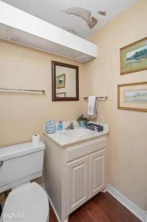 a bathroom with a toilet sink and mirror