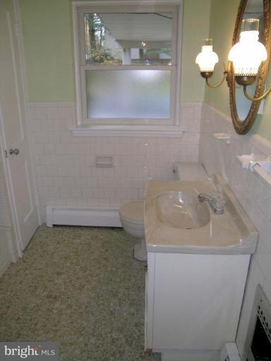 9217 Frederick Road Ellicott City, MD 21042 - Photo 14 of 22 a bathroom with a sink and a mirror