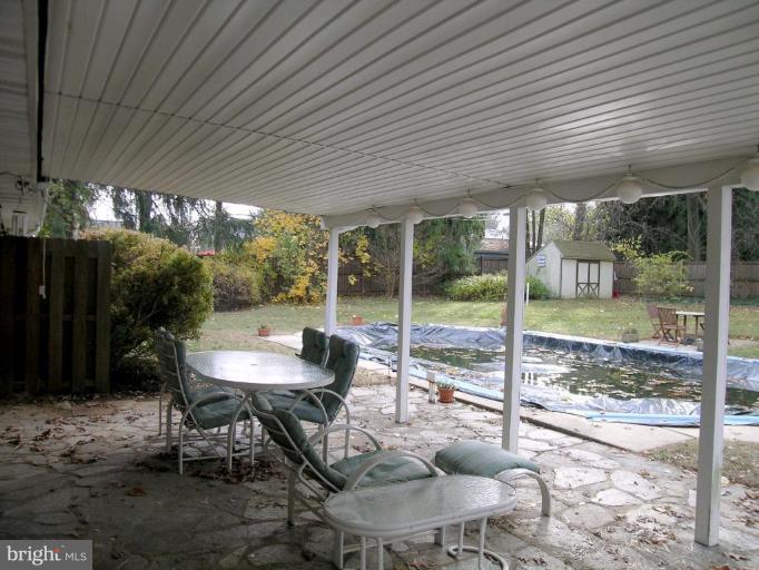 9217 Frederick Road Ellicott City, MD 21042 - Photo 15 of 22 a view of a patio with a table chairs and a backyard