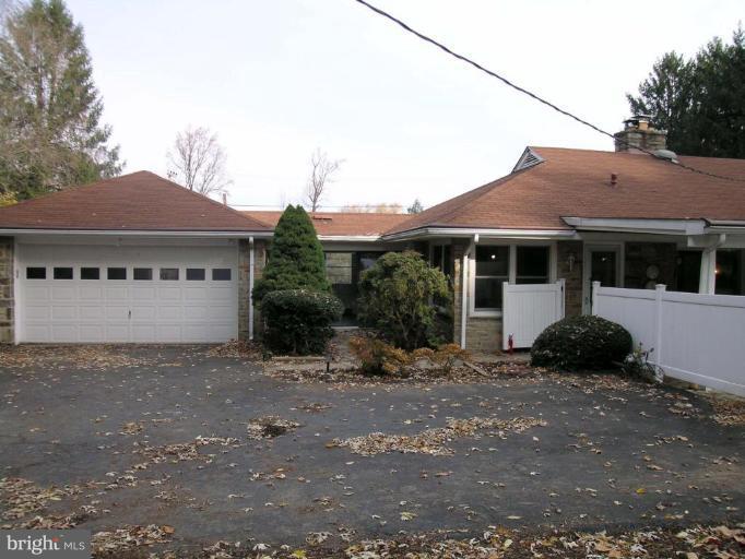 9217 Frederick Road Ellicott City, MD 21042 - Photo 20 of 22 a front view of a house with a garden