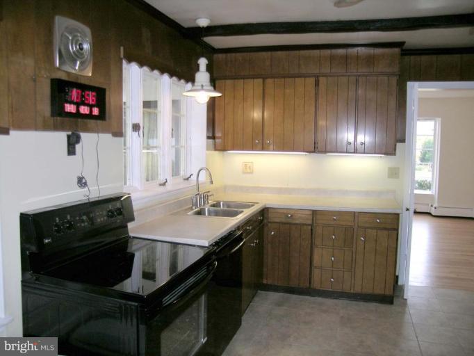 9217 Frederick Road Ellicott City, MD 21042 - Photo 4 of 22 a kitchen with a sink stove and cabinets
