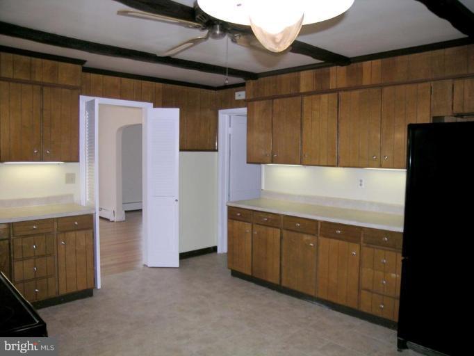 9217 Frederick Road Ellicott City, MD 21042 - Photo 7 of 22 a kitchen with cabinets and a refrigerator