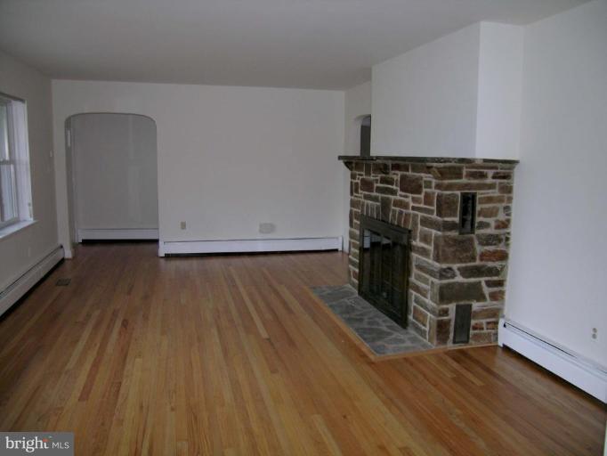 9217 Frederick Road Ellicott City, MD 21042 - Photo 9 of 22 a view of an empty room with wooden floor