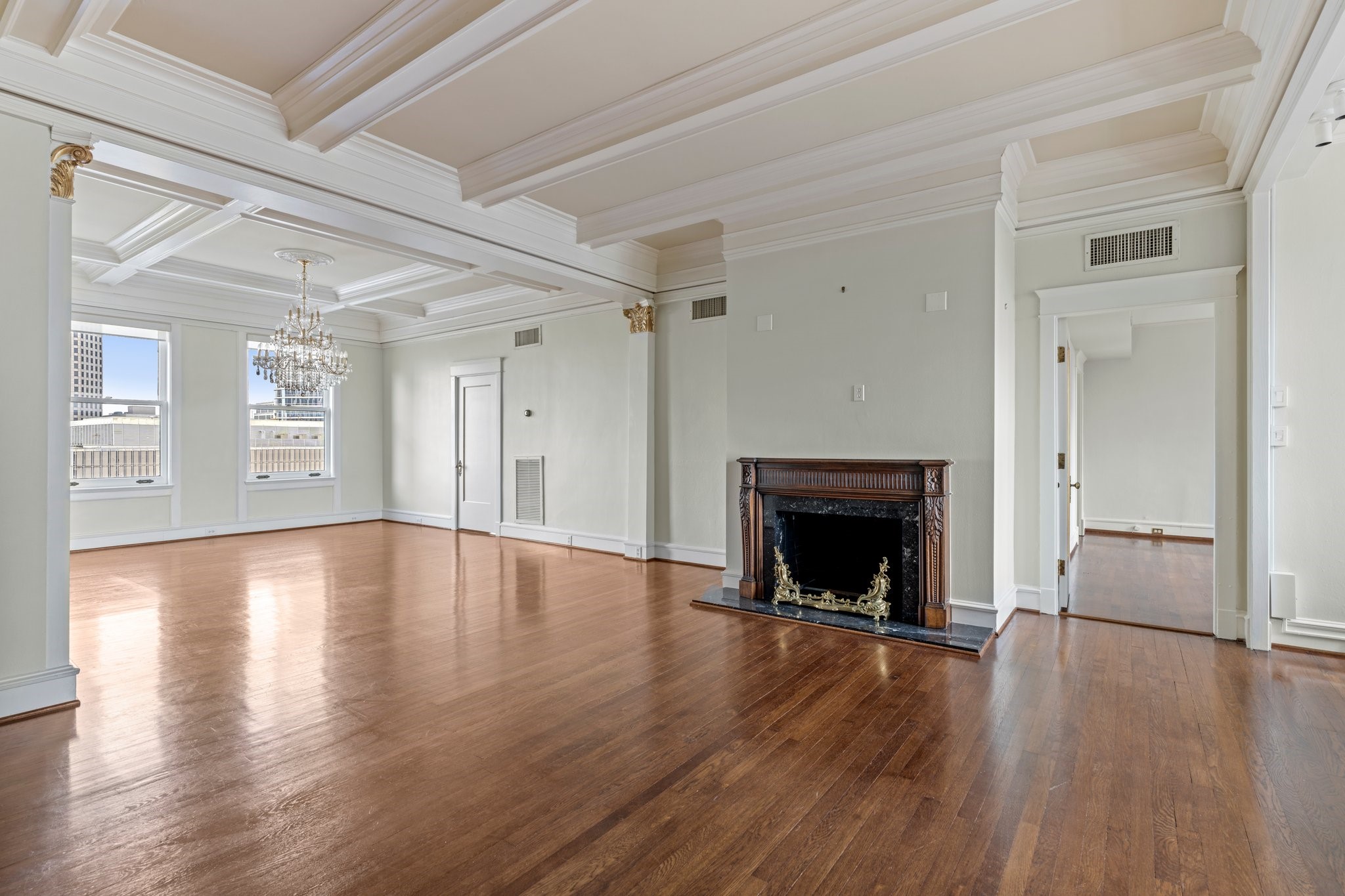 1700 Main Street, Unit 7B Houston, TX 77002 - Photo 2 of 50 a view of an empty room with wooden floor fireplace and a window