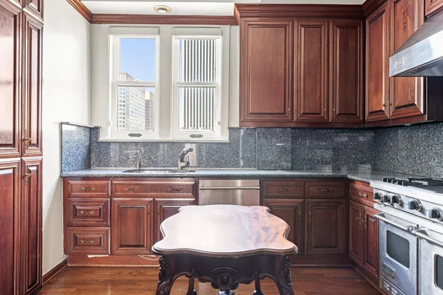 a kitchen with stainless steel appliances granite countertop a sink and cabinets
