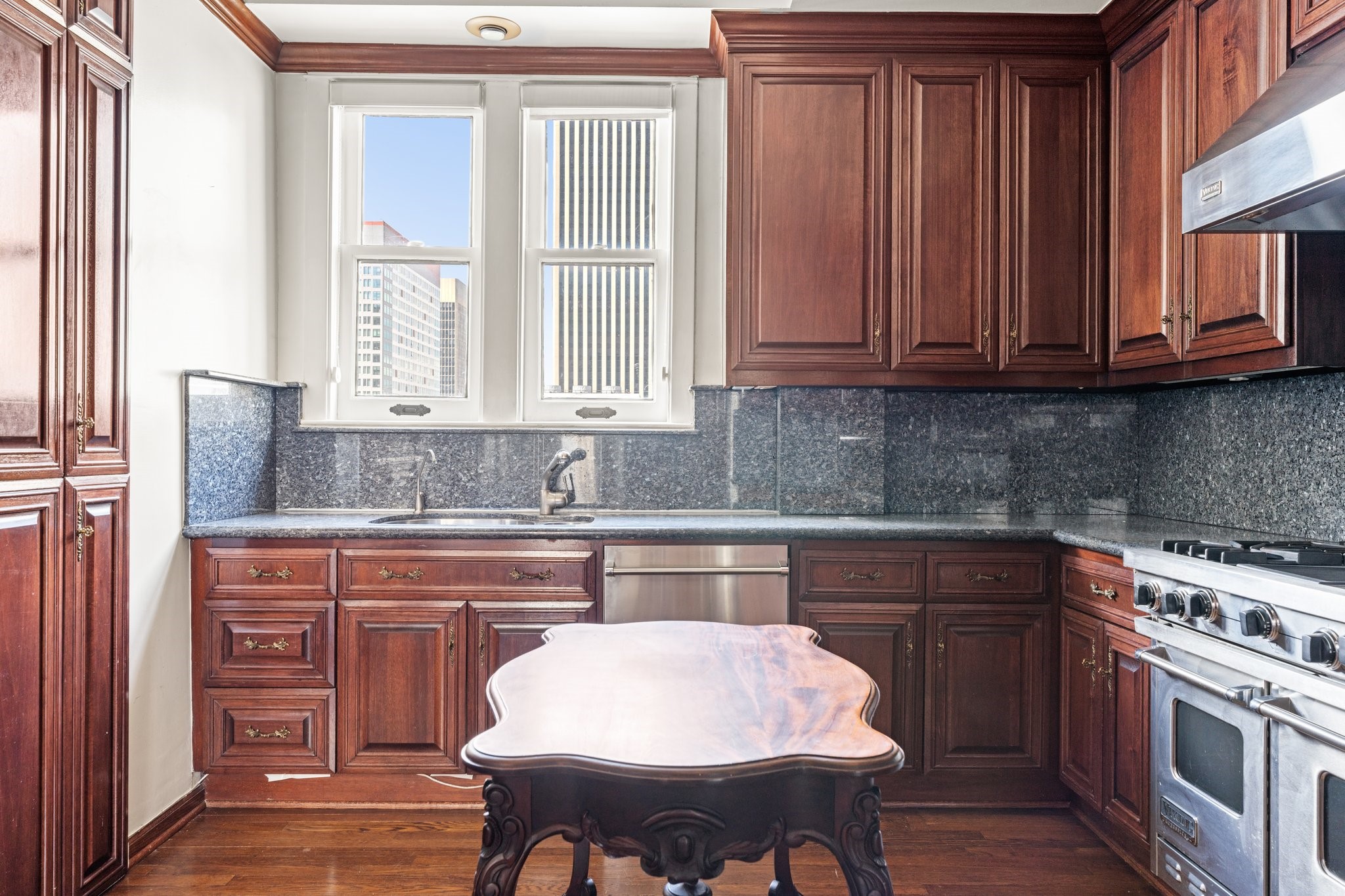 1700 Main Street, Unit 7B Houston, TX 77002 - Photo 24 of 50 a kitchen with stainless steel appliances granite countertop a sink and cabinets