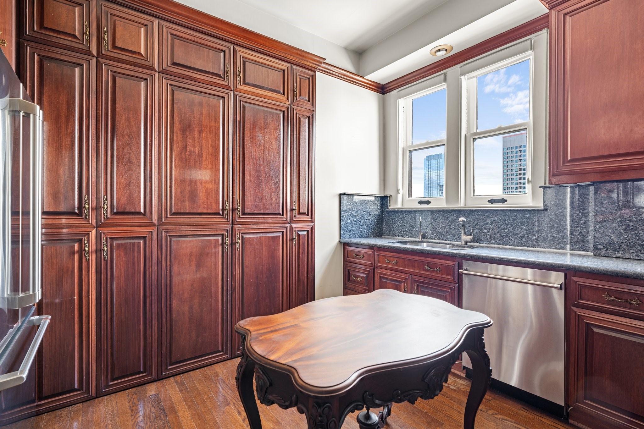 1700 Main Street, Unit 7B Houston, TX 77002 - Photo 25 of 50 a kitchen with wooden cabinets and sink