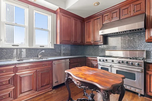 a kitchen with a stove a sink and a refrigerator