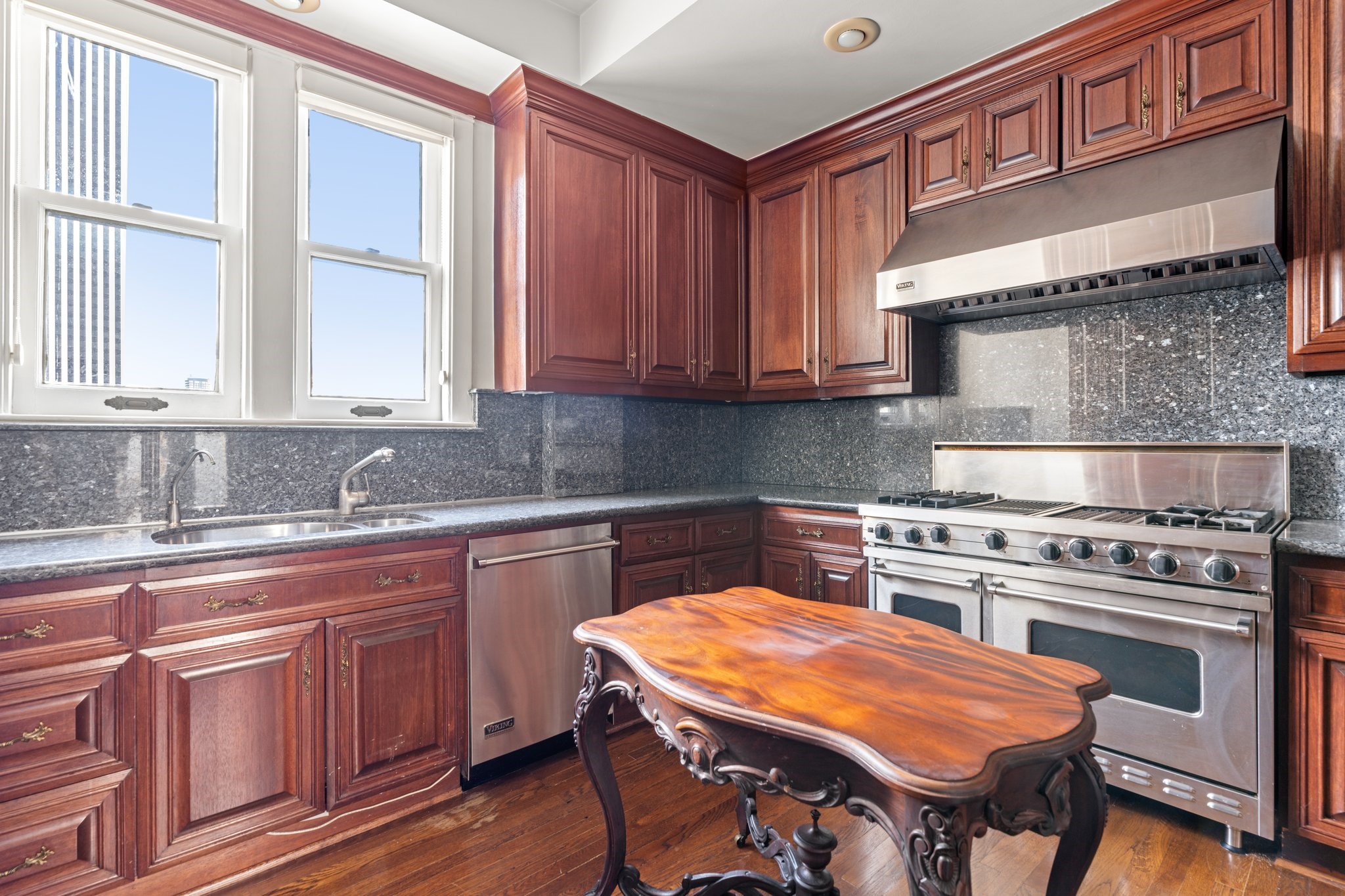 1700 Main Street, Unit 7B Houston, TX 77002 - Photo 27 of 50 a kitchen with a stove a sink and a refrigerator