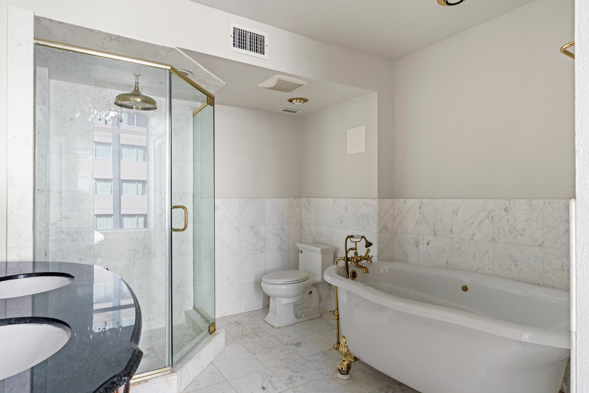 1700 Main Street, Unit 7B Houston, TX 77002 - Photo 30 of 50 a bathroom with a bathtub toilet and shower