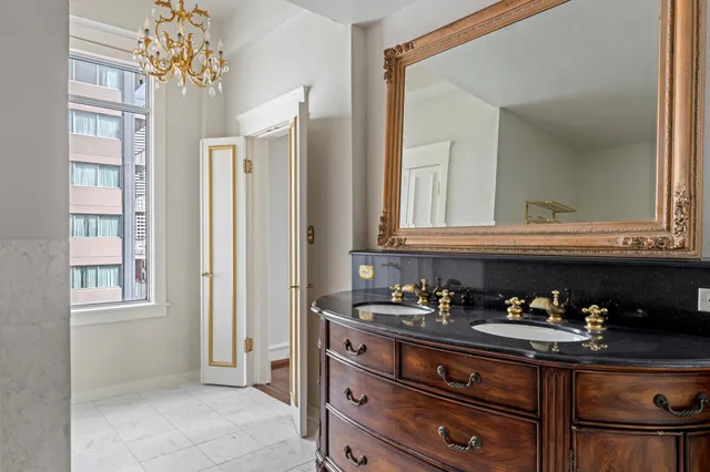 a bathroom with a sink a vanity and a mirror