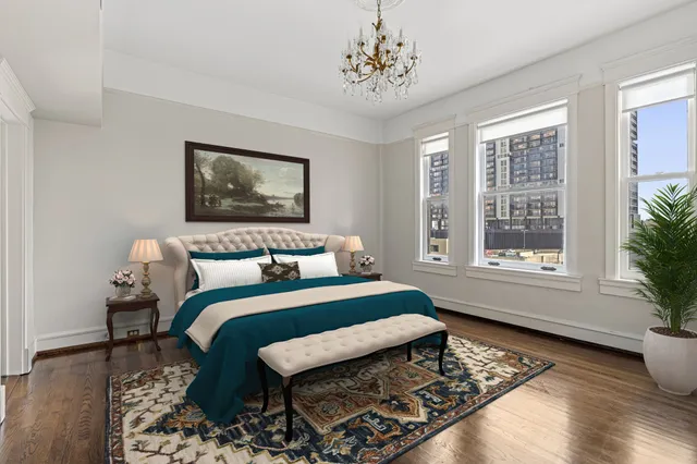 a bedroom with a bed and a painting on the wall